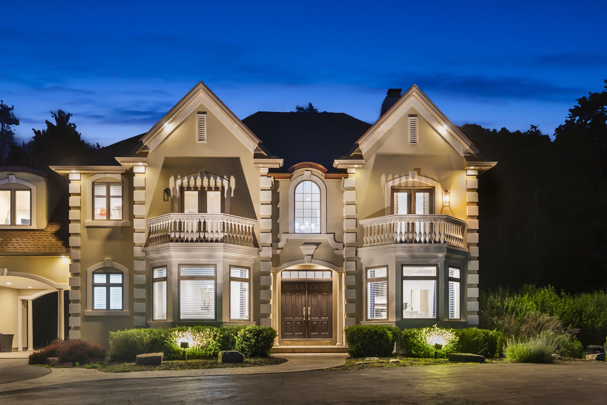 The Main House at twilight, lights on