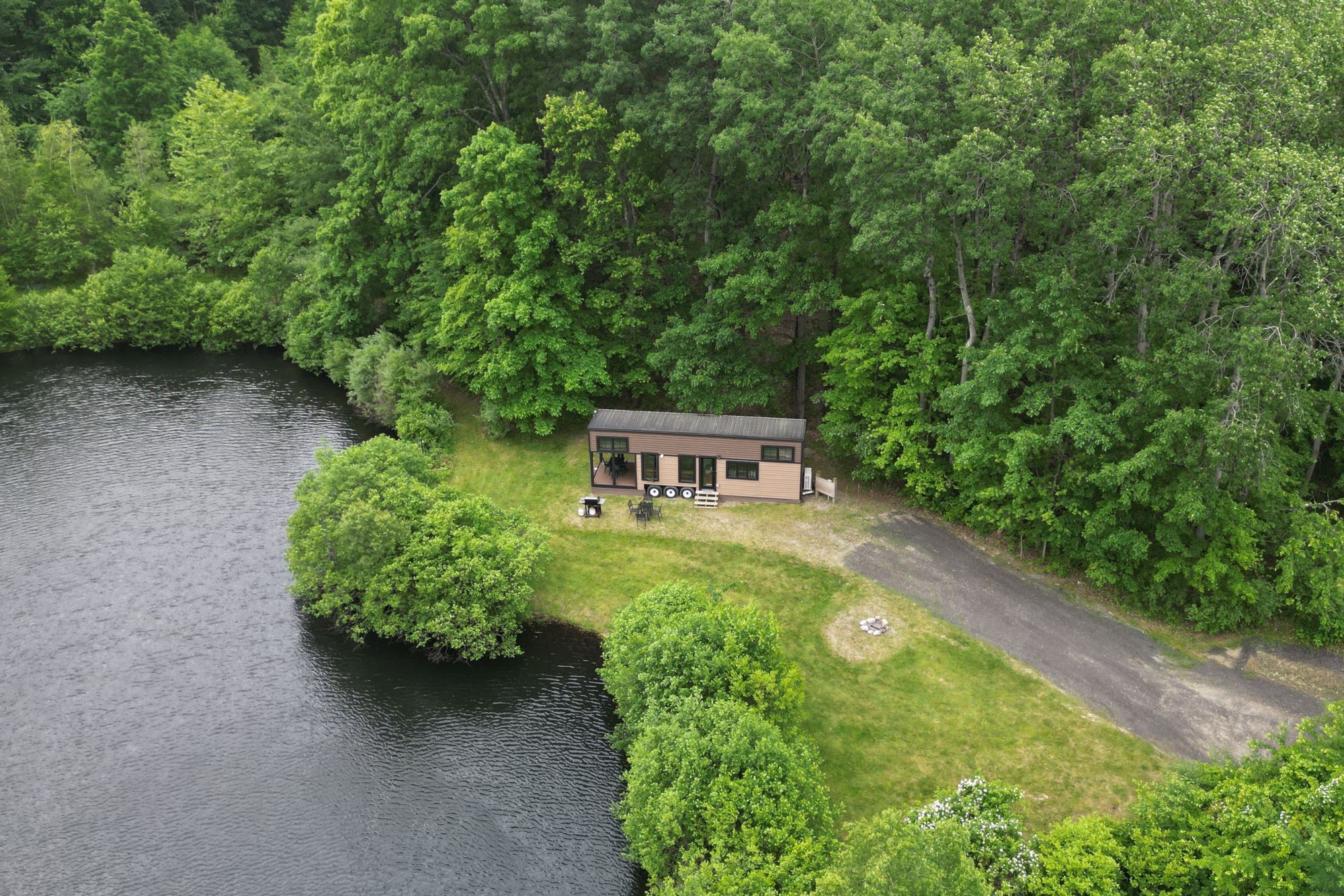 Pond, woods and cabin from above